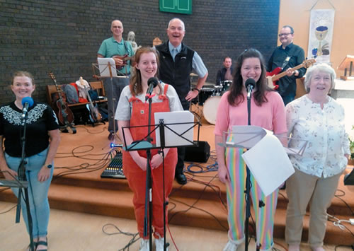 Fr. Boles with members of the &quot;Tongues of Fire&quot; rock band in the Wavertree parish church