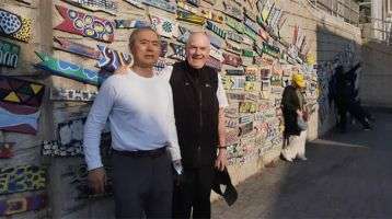 Fr. John Boles and Pelagio in front of one of Gamcheon's murals.