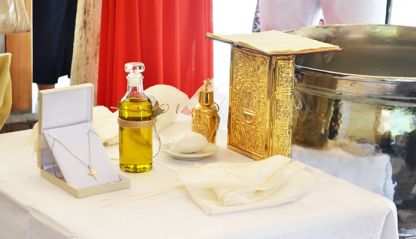 Table with holy chrism oil and other items for Catholic Confirmation