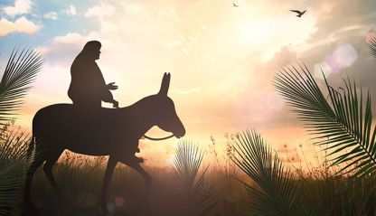 Jesus riding a donkey surrounded by palms