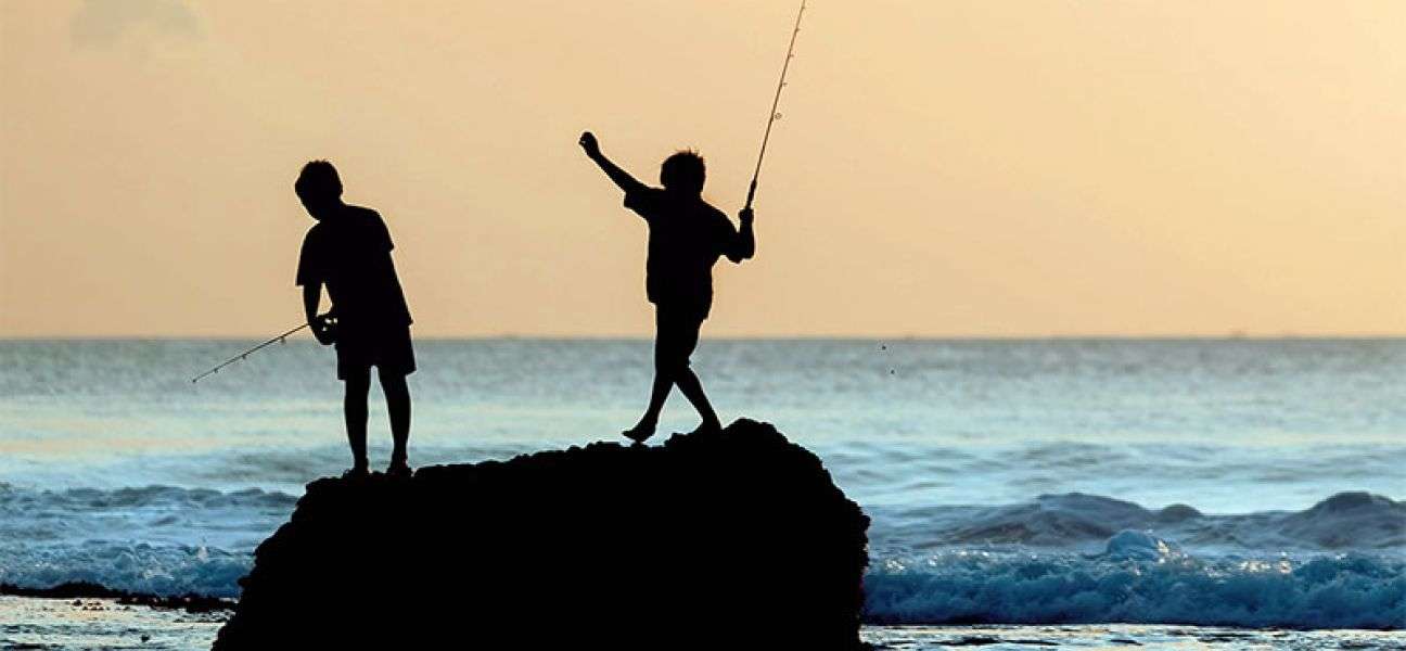 Children fishing from a rock