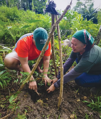 A man an worman planting seeds.