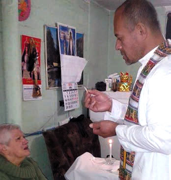 Fr. Napa gives communion to the sick.