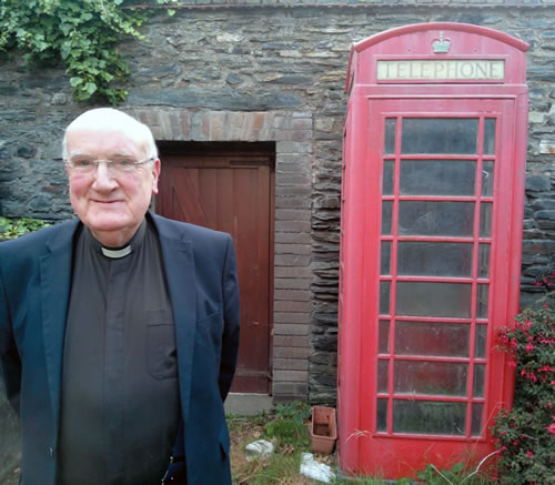 Fr. Brian O'Mahoney and his beloved red telephone
