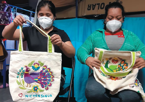 Migrants with their finished embroidery work