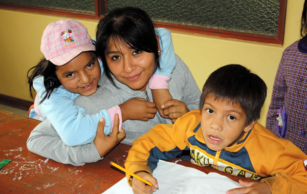A volunteer works with children and the center