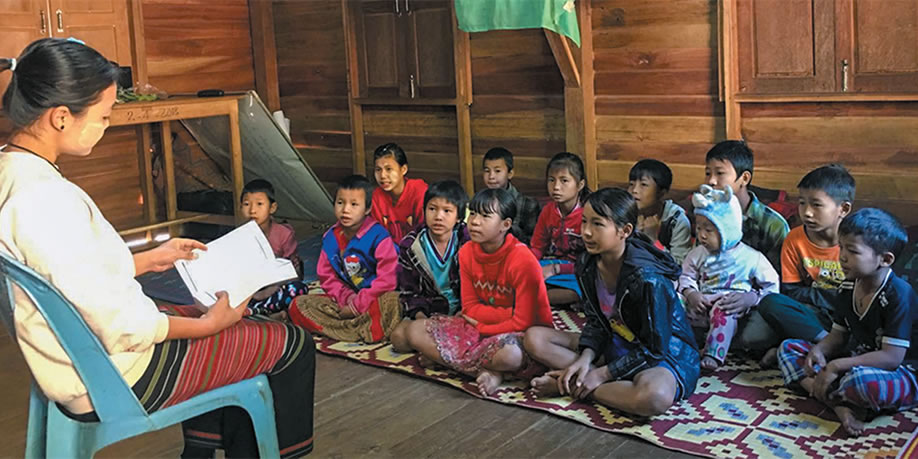 Teacher reading to school children
