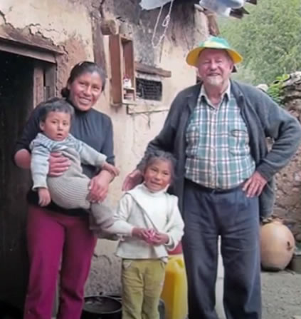 Columban Fr. Don Hornsey with a family in Peru.