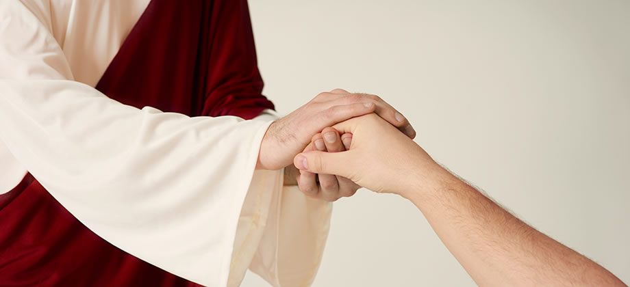 Jesus clasping the hand of a person.