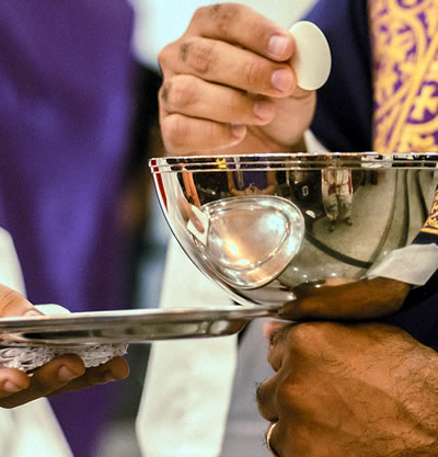 Priest with chalice and Eucharist