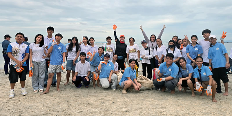 Anna (center in hat) with parish volunteers, at the 2025 International Coastal Cleanup