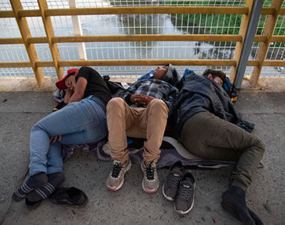 Migrants sleeping on a bridge