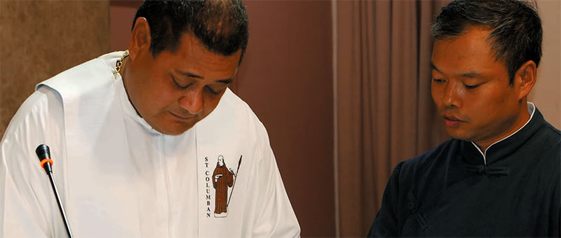 Columban Fr. Felisiano Fatu signs Peter's Society membership form.