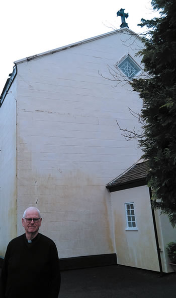 Person standing in front of the &quot;barn&quot; chruch