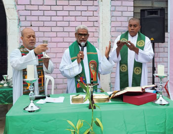 Fr. Martin (right) at Mass
