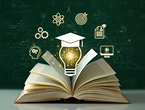 An open textbook in front of a chalkboard with a light bulb above it.