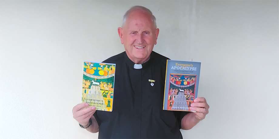 Fr. Donal McIlwraith holding books