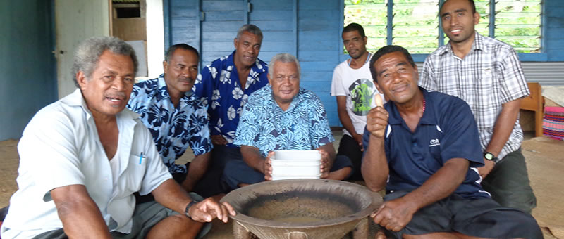 A group of Fijian men sitting around the yaqona bowl