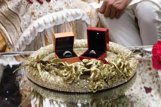 Rings sit on a table in preparations for the Pakistani couple's wedding.