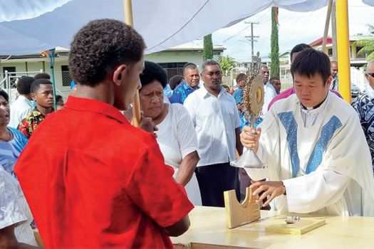 Columban Fr. Carlo Jung Euikyun with parishioners during the Corpus Christi Sunday procession