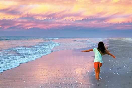 A young girl running on the beach