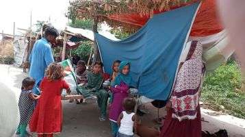 People create make-shift tents the River Indus