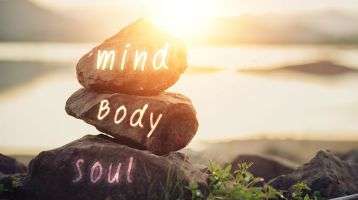 stacked rocks with words mind, body, soul