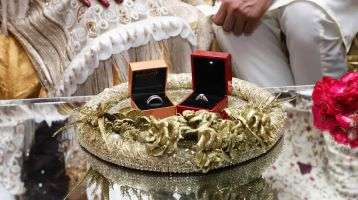 Rings sit on a table in preparations for the Pakistani couple's wedding.