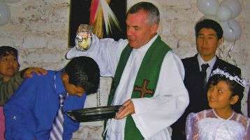 Columban Fr. John Boles Baptizes a chile