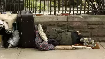 Homeless person sleeping on park bench
