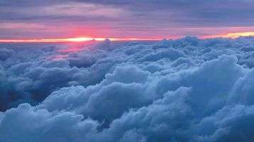 The sun rising above the clouds