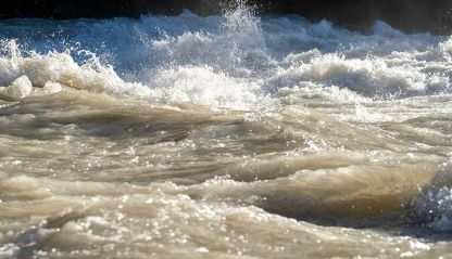 A raging river splashing water