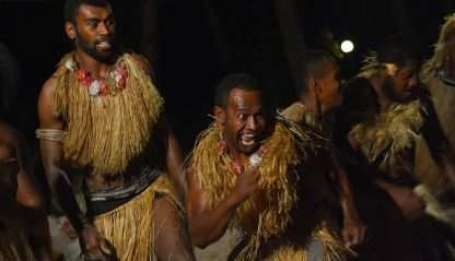 Fijian men dancing a traditional male dance meke wesi the spear dance.