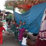 Families create make-shift tents