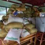 Bags of grain on a table above flood waters