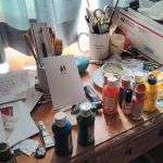 Paints and notes on Fr. Bill's painting desk.