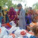 A Christian family in Manori receives food ration.