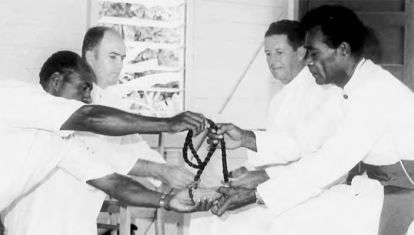 Receiving the whale tooth, the highest Fijian honor
