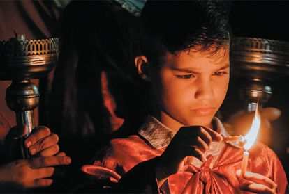 Child lighting a candle