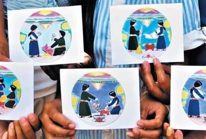 Subanen crafters holding their hand-made Christmas cards