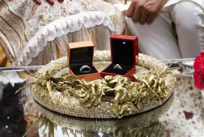 Rings sit on a table in preparations for the Pakistani couple's wedding.