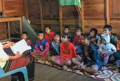 Teacher reading to school children