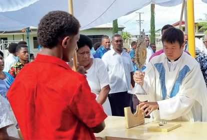 Columban Fr. Carlo Jung Euikyun with parishioners during the Corpus Christi Sunday procession