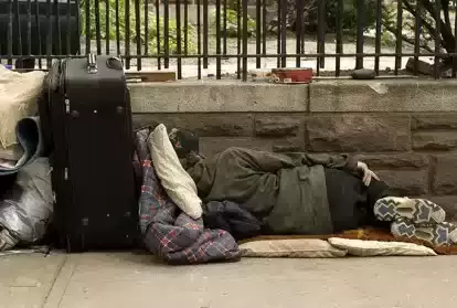 Homeless person sleeping on park bench