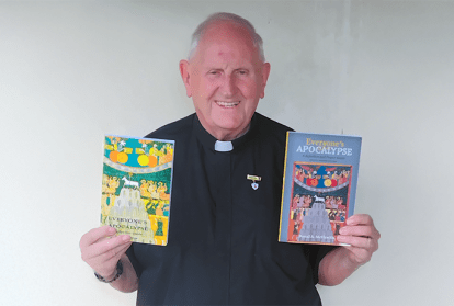 Fr. Donal McIlwraith holding books