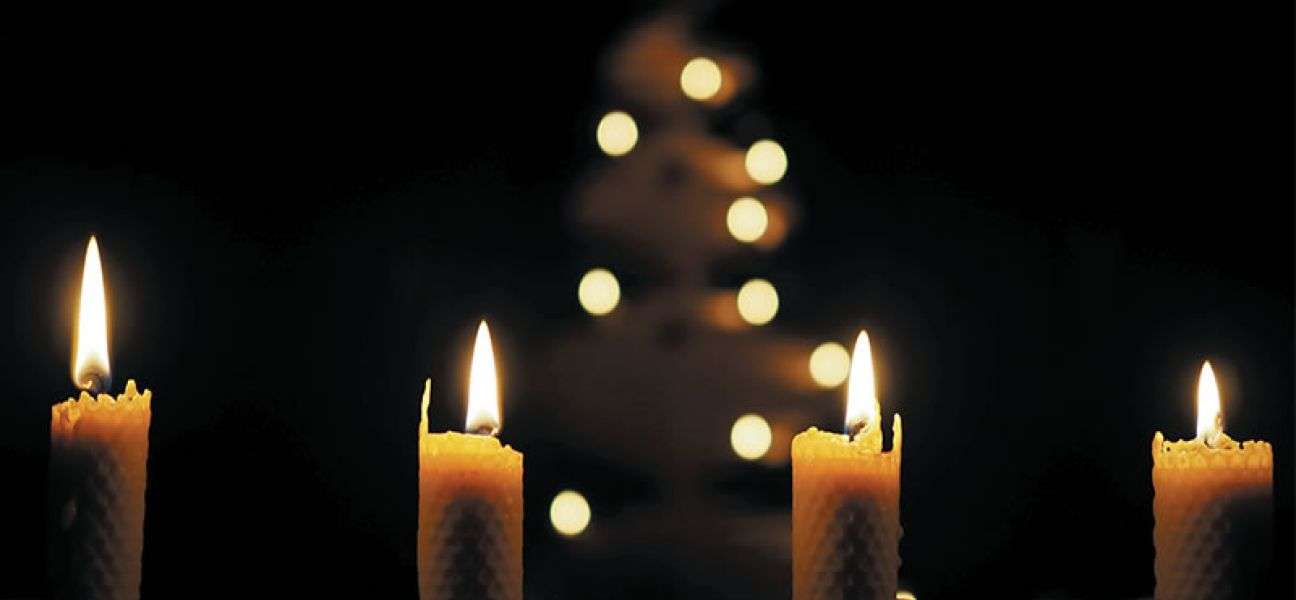 lit candles in a darkened church