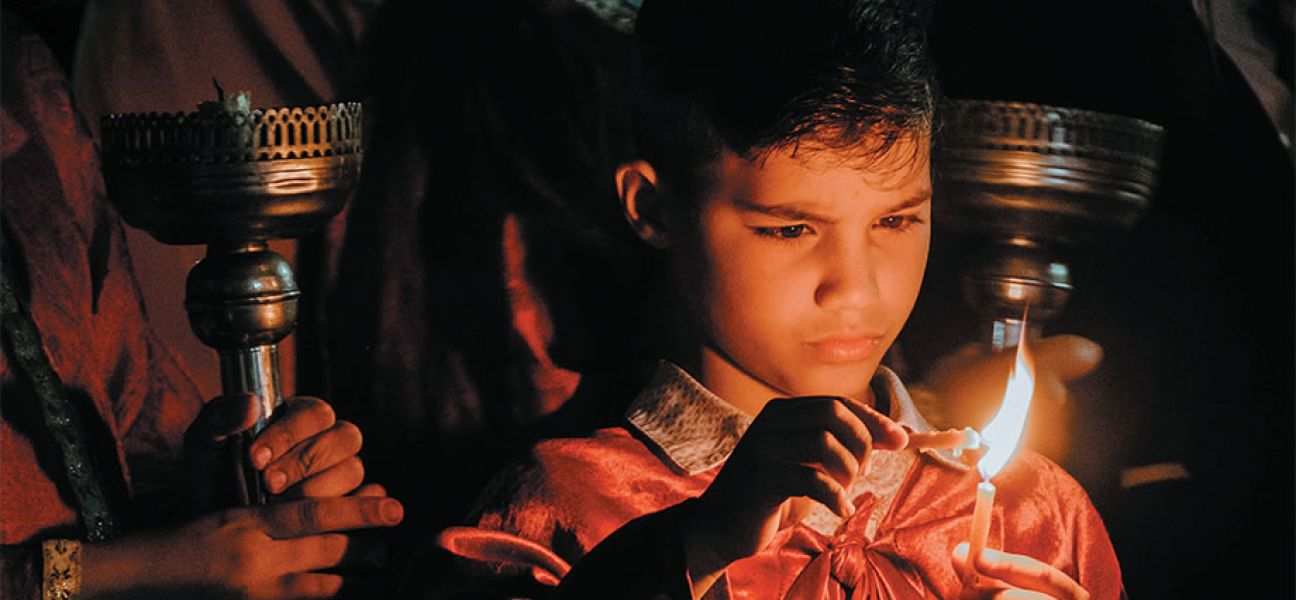 Child lighting a candle