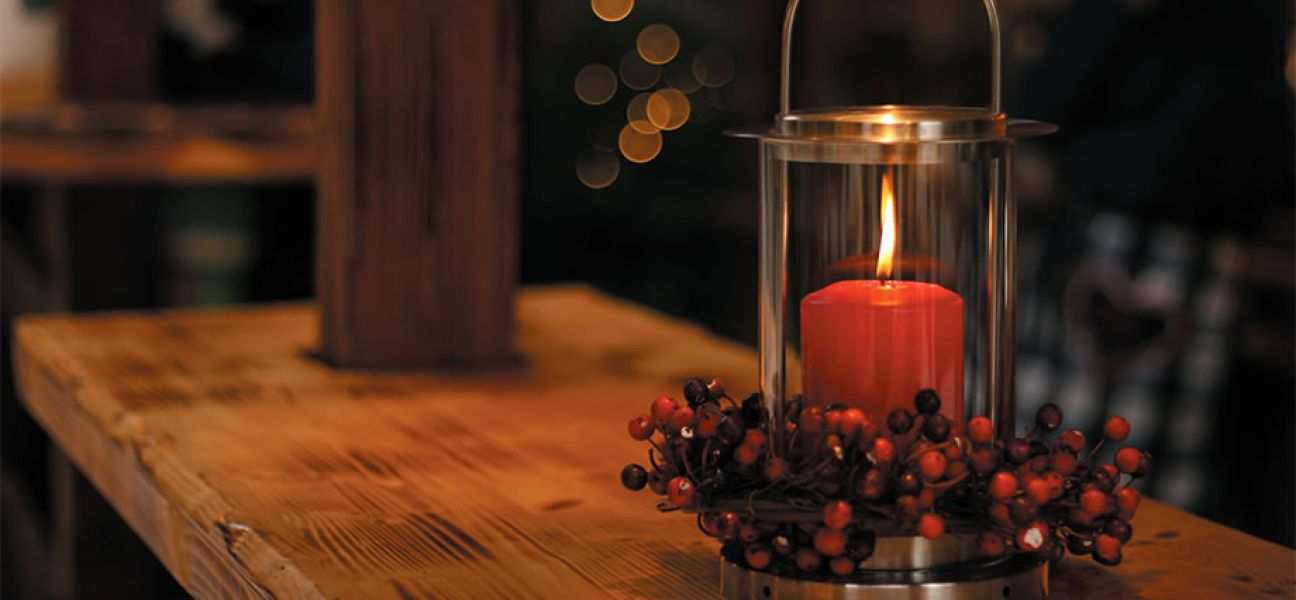 A lighted candle on a table