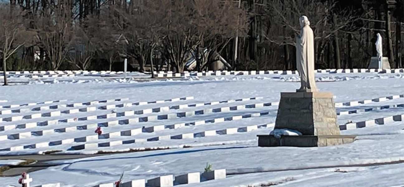 Snow blankets a cemetery 