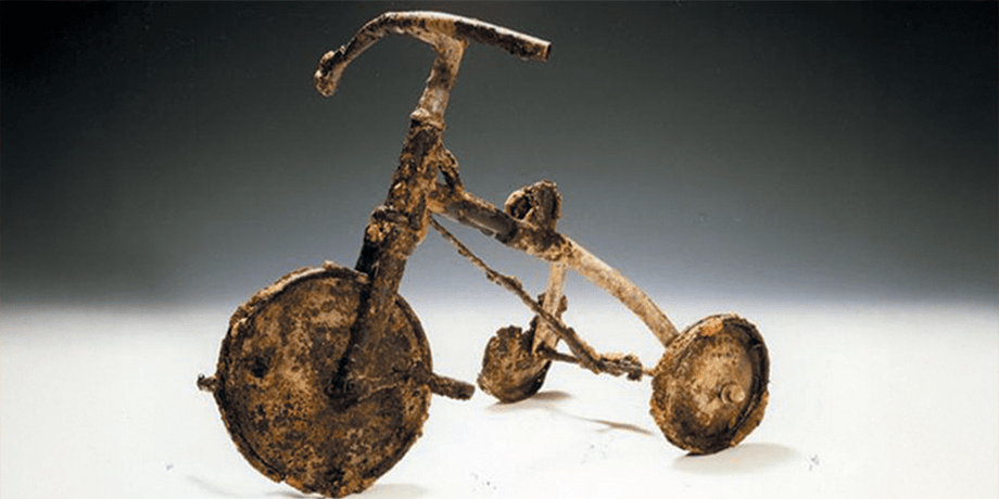 A child's tricycle, burnt and twisted, at the Atomic Bomb Memorial Museum